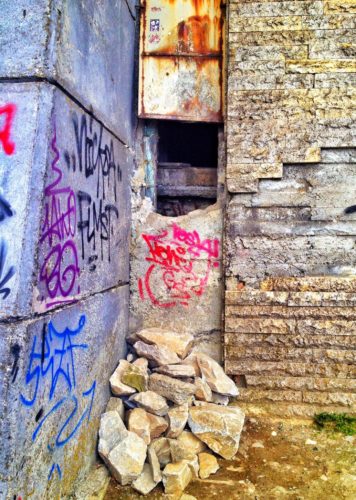 The current entrance into Buzludzha, which is a hole in the side of the wall, and its "stairs", which are built out of rubble