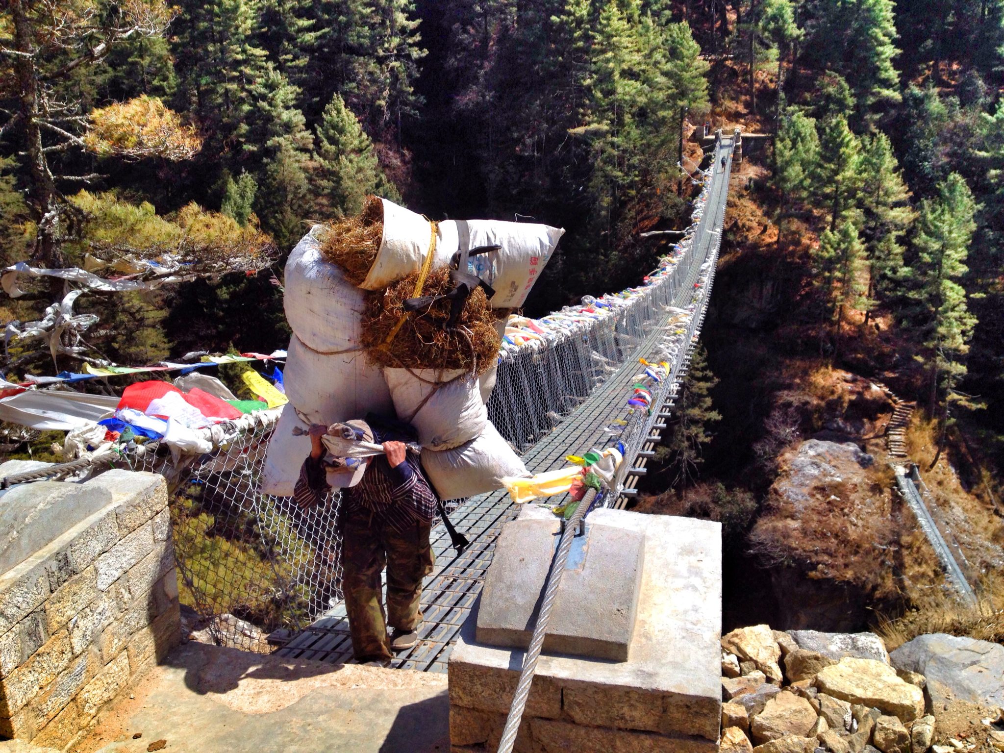 A Sherpa hiking carrying materials headed up to Mount Everest Base Camp
