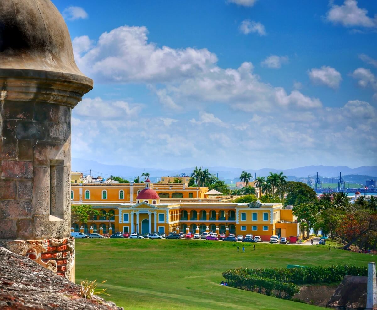 The perfectly blue skies and yellow government buildings in the distance from the Castillo San Felipe del Morro in San Juan