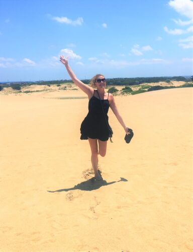 Solo female frolicking through the sand dunes