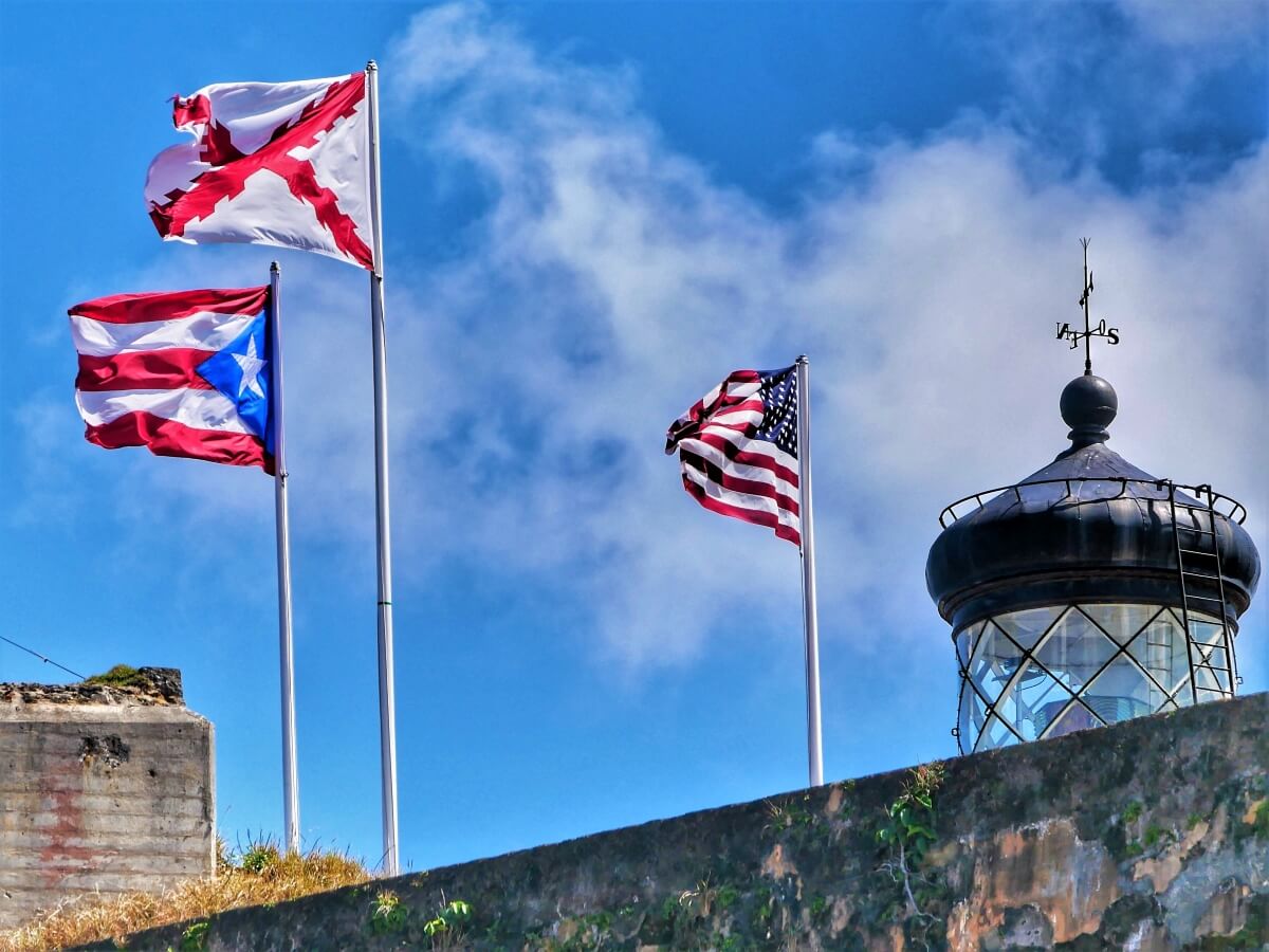 Puerto Rican and American flags blowing in the breeze in Old San Juan