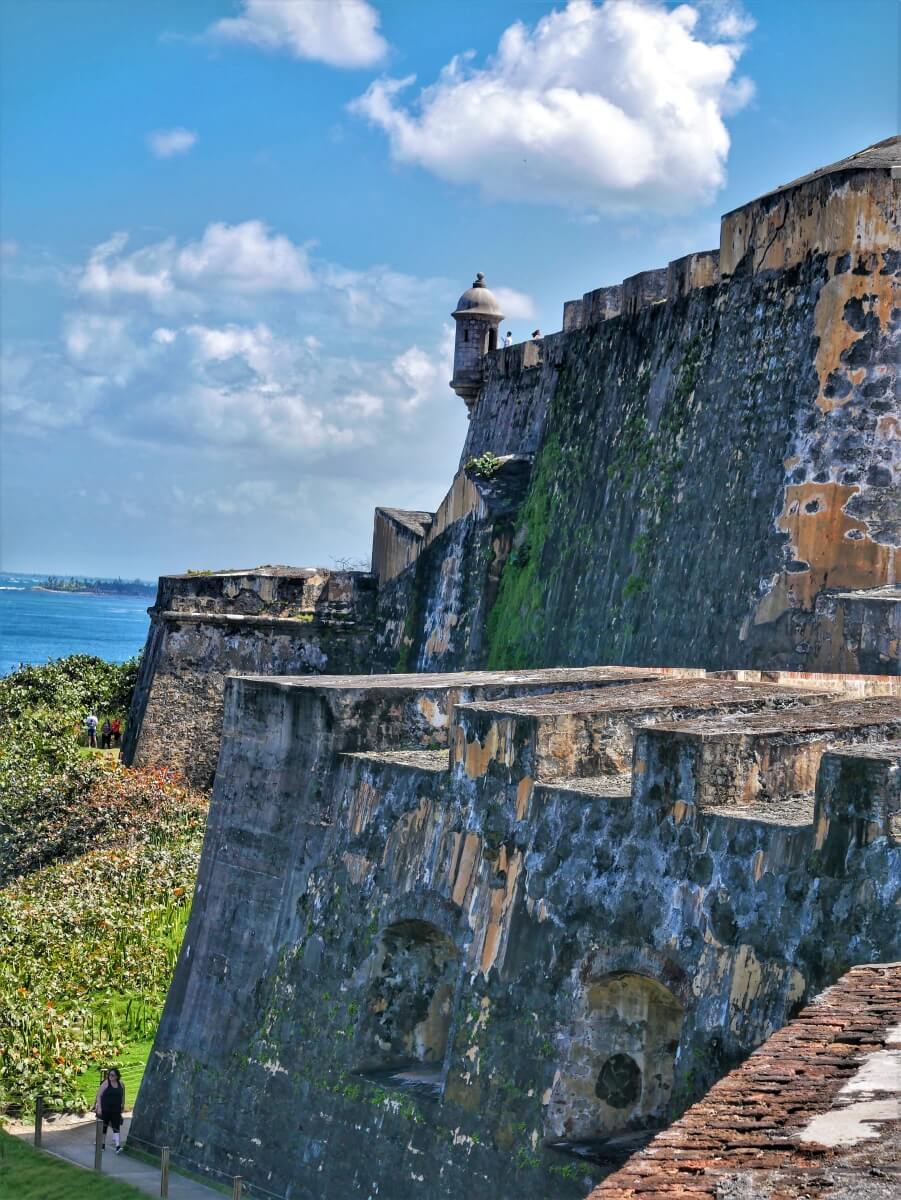 The side of a fort on a blue skied day