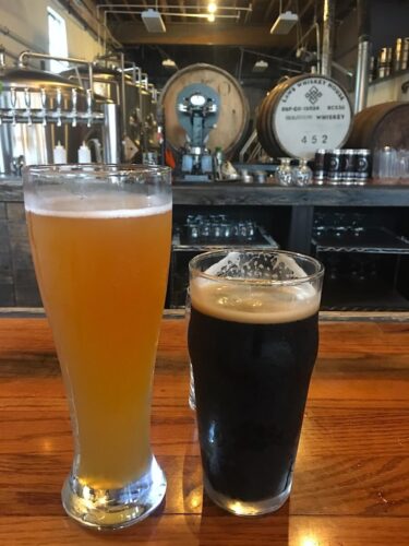 2 beers sitting next to each other in a brewery