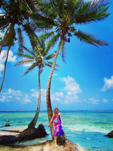Woman posing with a palm tree