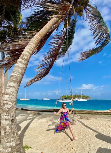 Swinging on a palm tree on the beautiful San Blas Islands