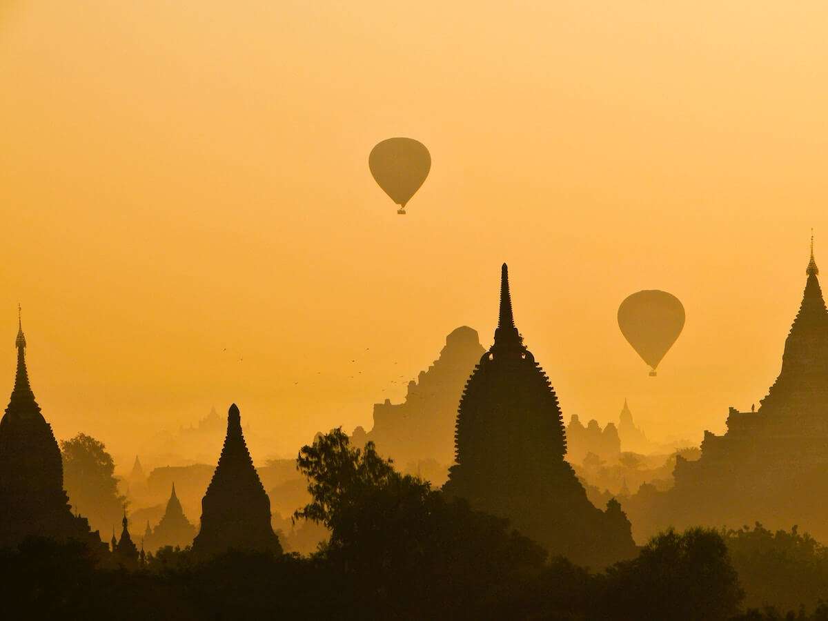 Temples and hot air balloons in Bagan at sunrise