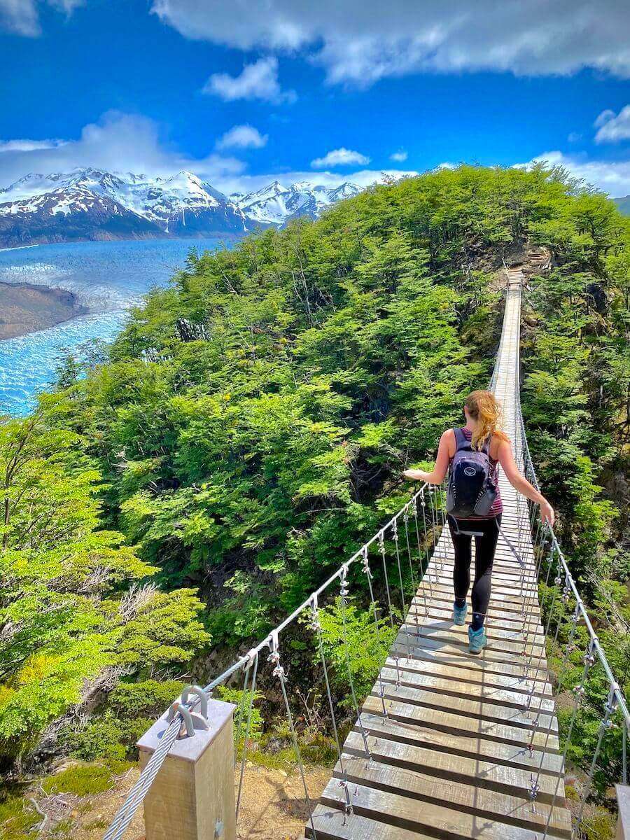 Julia crossing a bridge in Torres del Paine, Chile