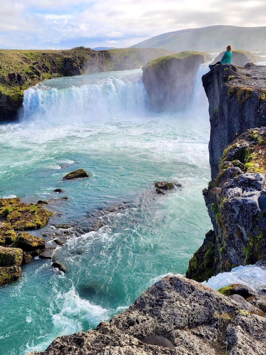 Julia sitting above Iceland Waterfall