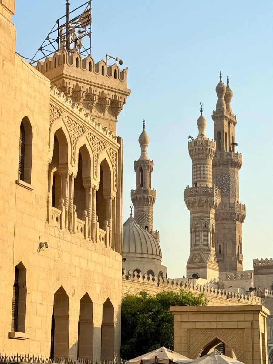 Ancient mosque with tall minarets in Cairo, Egypt, during daytime.