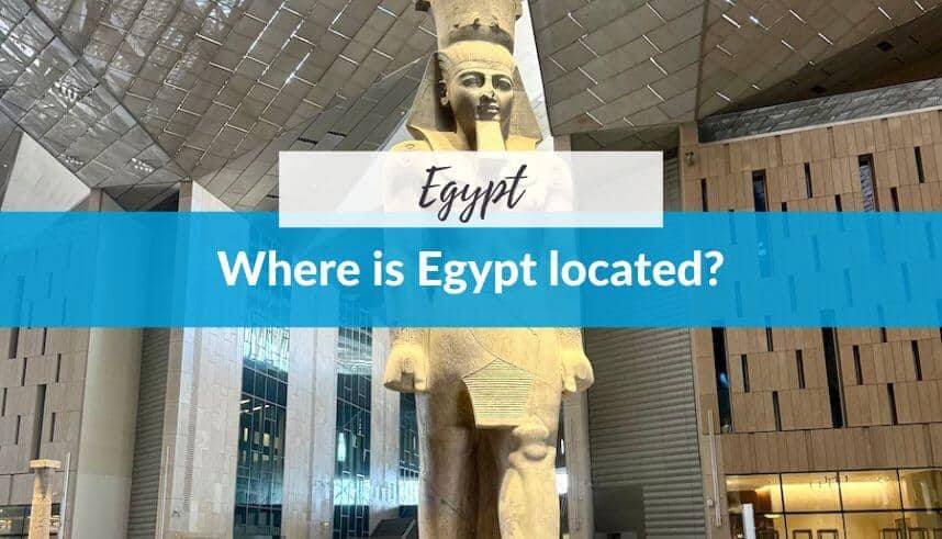 Ancient Egyptian statue inside a modern building with a sign asking about Egypt's location.