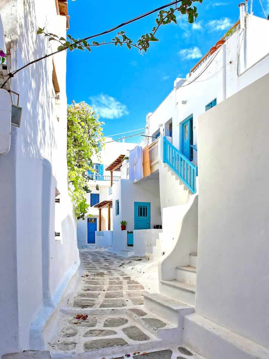 White-washed buildings with blue accents in a Greek island village.